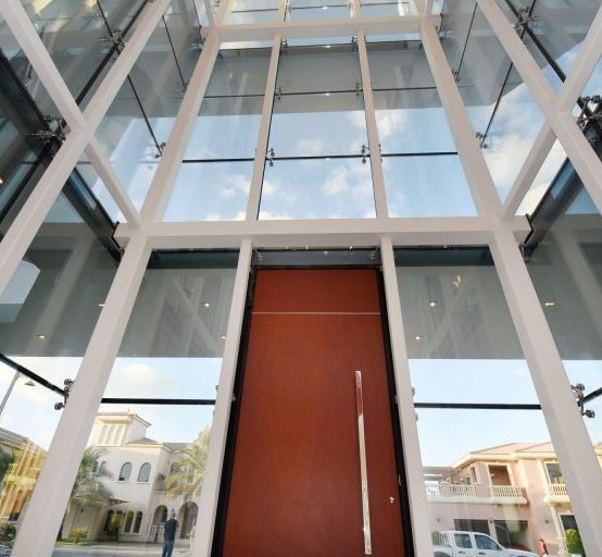 Storefront with big Brown entry door in a High Commercial Building