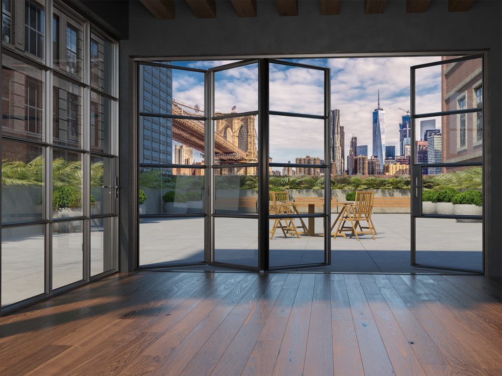 Black-framed folding glass doors open onto a spacious terrace, offering a breathtaking view of the New York City skyline, with One World Trade Center and various skyscrapers visible in the distance, along with the Brooklyn Bridge partially in frame on the left, the interior features dark wooden flooring with a rich, warm tone, contrasting with the sleek metal and glass elements of the doors and windows, which allow abundant natural light to fill the space